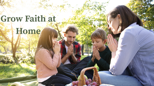 Family prays together outside over picnic lunch